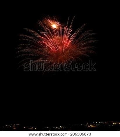 Red colorful fireworks isolated in dark background with building silhouethe on the bottom close up with the place for text, Malta fireworks festival, 4 of July, Independence day, New Year, explode