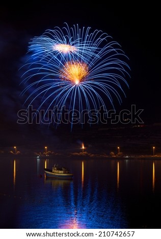 Colorful fireworks explosion in dark sky background, 4 of July, Independence day, explode, fireworks festival fragment close up nice reflection in water in Malta,Malta fireworks festival, explode