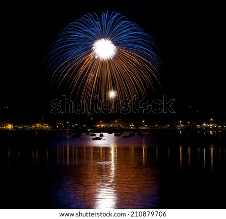 Colorful fireworks explosion in dark sky background, 4 of July, Independence day, explode, fireworks fragment with reflection on a water in background in Malta,Malta fireworks festival, Marsaxlokk