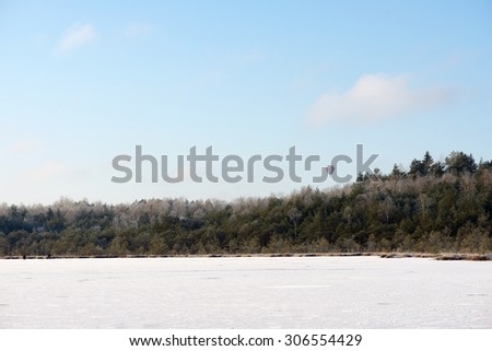 Winter landscape, Frozen lake in winter time and ballon crossing the forest, winter background, lake with ice, frozen background, ice, frozen, winter. Winter time in Lithuania