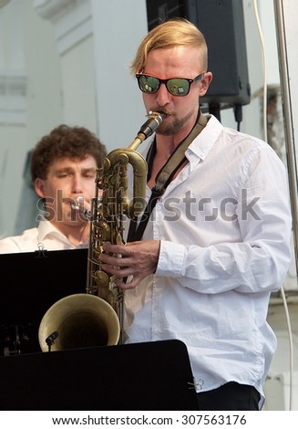 Uzutrakis, Lithuania - August 9: Musicians with big band orchestra playing in the jazz concert in Uzutrakis, Lithuania on August 9, 2015. Summer culture events in Uzutrakis  in Lithuania