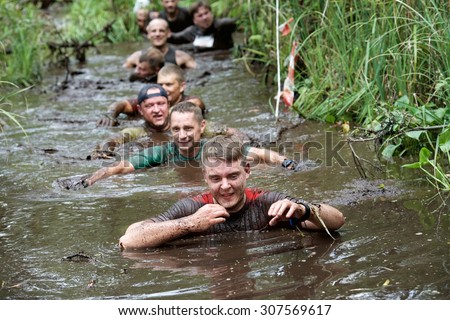 Sirvintos, Lithuania - August 9: Beaver run or Lithuanian version of best known as Tough Mudder in Sirvintos district in Lithuania on August 9, 2015. Team work concept