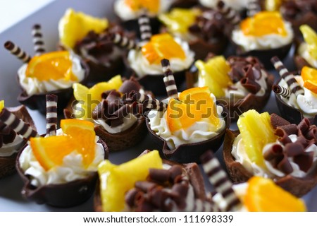 Platter of orange cream chocolate basket mini desserts filling the frame
