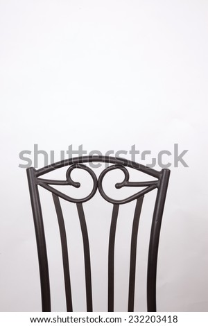 The back of a chair on a white background.