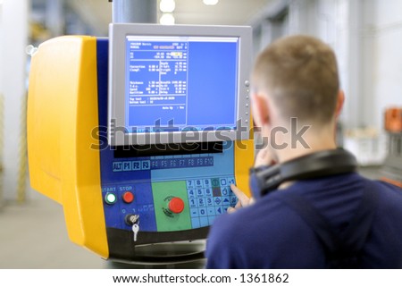 Man working at programmable machine. Sheet metal bending. Focus on monitor