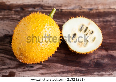 Gac,Baby Jackfruit Spiny Bitter Gourd, Sweet Gourd.A Southeast Asian fruit isolate on wood.