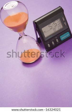An hour-glass style timer and a digital clock.
