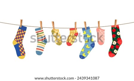 Clothesline with socks and clothespins hang on rope, fluttering in the breeze. Cartoon vector colorful pairs for kids and adults hang side by side, creates a display of drying laundry in the sunshine