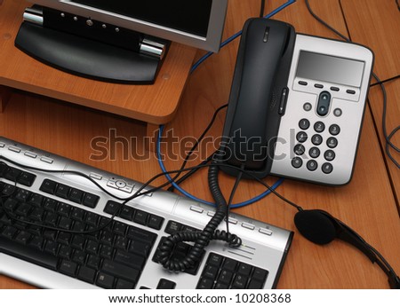 Digital phone and computer lying in a mess