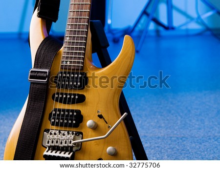 Electric 24-fret guitar closeup isolated on white background