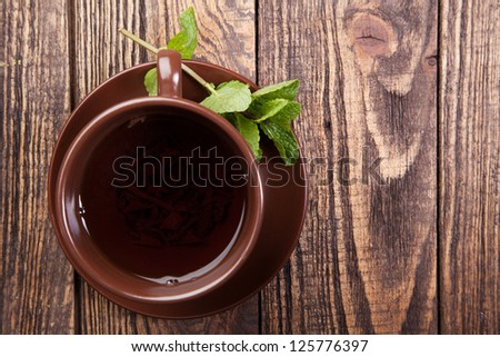 Tea with mint on a wooden table - studio still life