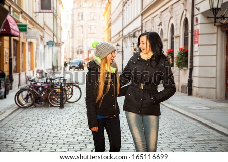 Two girl friends in the street in winter clothing
