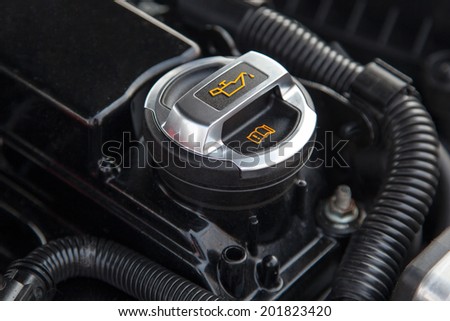 Motor oil cap under the hood of a car