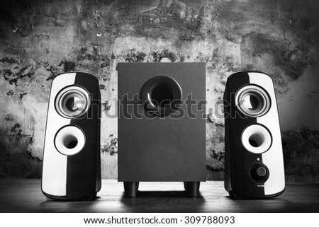 Modern black sound speakers on dark background