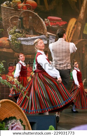 RIGA, LATVIA -?? SEPTEMBER 27, 2014: People in national costumes perform traditional dances on the scene during the Latvian harvest holiday Mikeldienas.