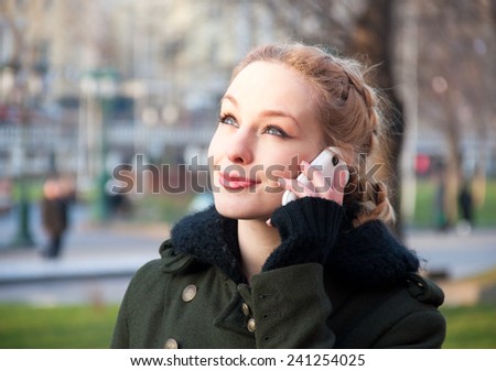 Young woman talking on mobile phone on the street