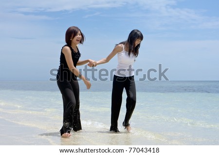 http://image.shutterstock.com/display_pic_with_logo/1056/1056,1305178247,5/stock-photo-friendship-couple-having-fun-on-the-beach-enjoying-their-summer-holiday-together-77043418.jpg