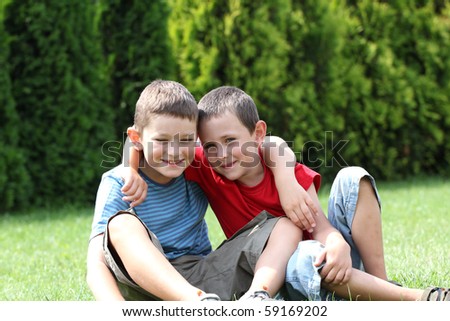 Portrait of two boys, siblings, brothers and best friends smiling. Friends hugging.