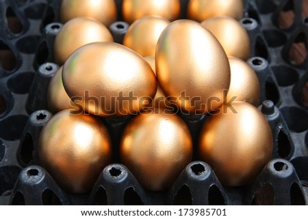 Golden eggs on black package