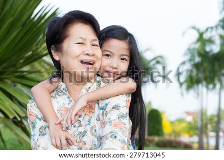 Grandma and grandchild hugging in the park