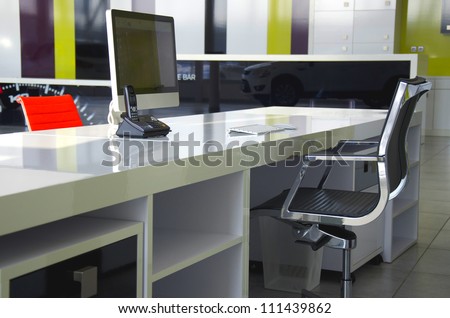 Modern office interior with red chairs and white furniture