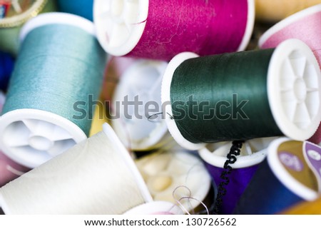 Colorful spools of thread in a pile in tailor shop.