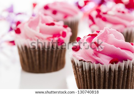 Pink Valentine\'s day cupcakes on white background.