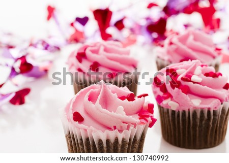 Pink Valentine\'s day cupcakes on white background.
