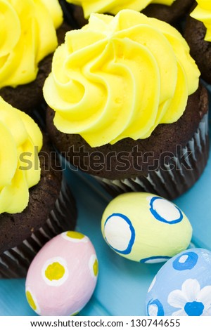 Gourmet cupcakes with yellow icing prepared for Easter.