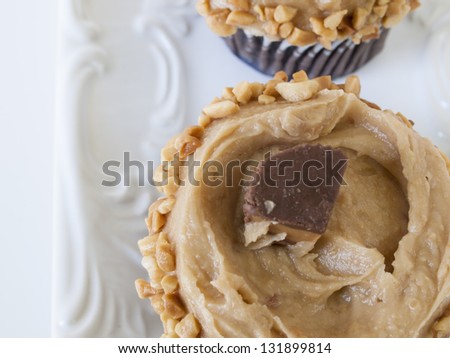 Gourmet peanut butter cups cupcake on white background.