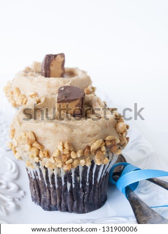Gourmet peanut butter cups cupcake on white backround.
