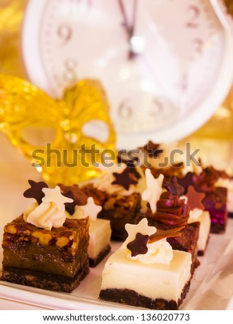 Gourmet assorted petite party pastries decorated for New Year Eve celebration.