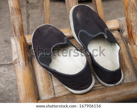 Old chinese shoes on the chair.