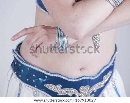 A woman performing as a belly dancer.