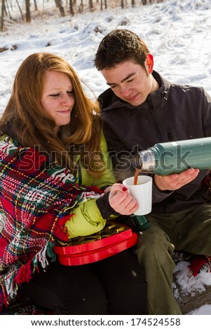 https://image.shutterstock.com/display_pic_with_logo/1059122/174524558/stock-photo-young-couple-at-the-picnic-on-the-valentines-day-in-a-snowy-park-174524558.jpg