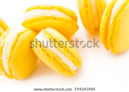 Gourmet small colorful French macarons with lemon flavor.