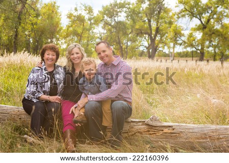 Lovely family enjoying weekend in open space park in early Autumn.