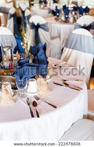 Banquet hall decorated for wedding in white and blue.