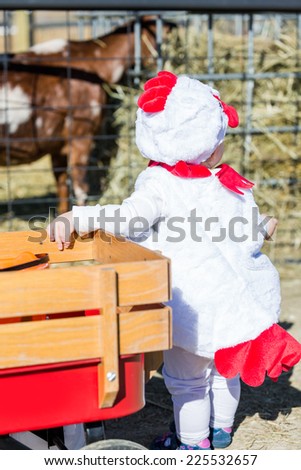 Cute kids in Halloween costumes at the petting zoo.