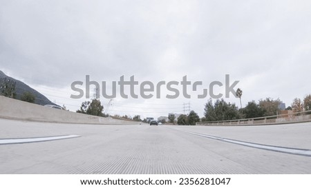 Similar – Image, Stock Photo Driving through Los Angeles in a convertible. LA, California.
