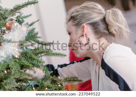 Family decorating beautiful live Christmas tree.