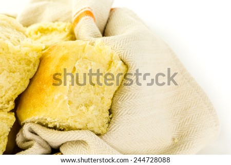 Freshly baked sourdough dinner rolls on a white background.