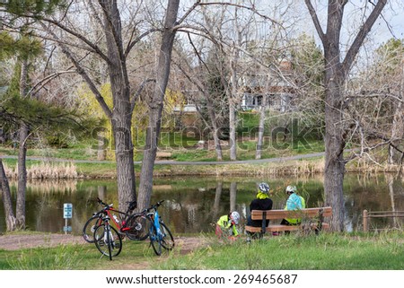 Denver, Colorado, USA-April 11, 2015. Family on bike ride in urban park on weekend.