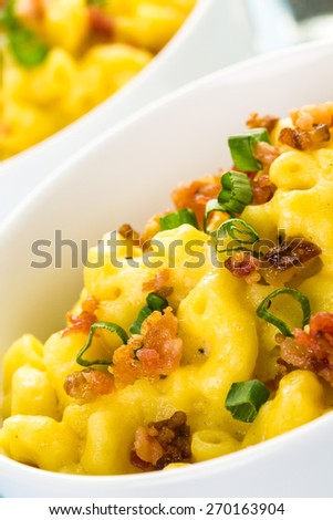 Macaroni and cheese garnished with bacon bits and chives.