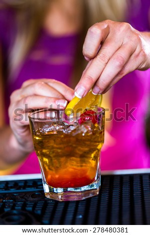 Bartender making new old fashioned cocktail in Italian restaurant.