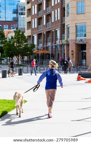 Denver, Colorado, USA-May 17, 2015. Typical walk with a dog in the ity on Sunday morning.
