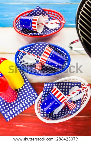 Table set with white, blue and red decorations for July 4th barbecue.