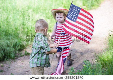 Toddlers having fun in the park for July Fourth.