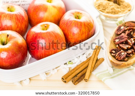 Ingredients for preparing homemade baked apples from organic apples.