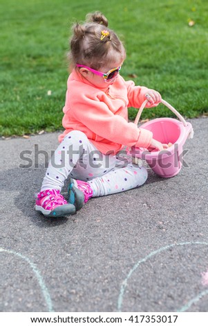 Toddler Girl Drawing on Her Face with Sidewalk Chalk Stock 